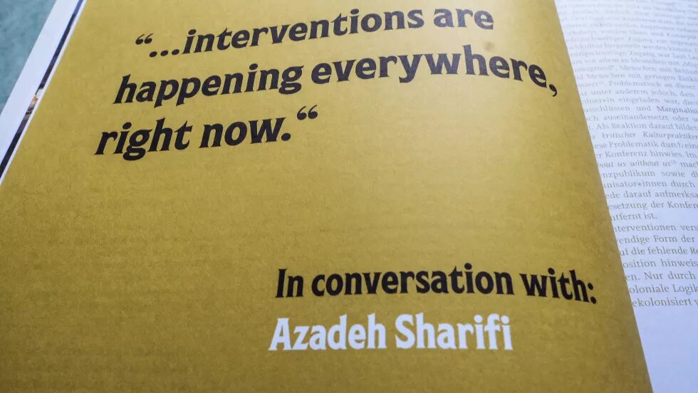 Aufgeblättertes Magazin. In schwarzer Schrift steht auf gelben Hintergrund "...Interventions are happening everywhere, right now." In conversation with Azadeh Sharifi